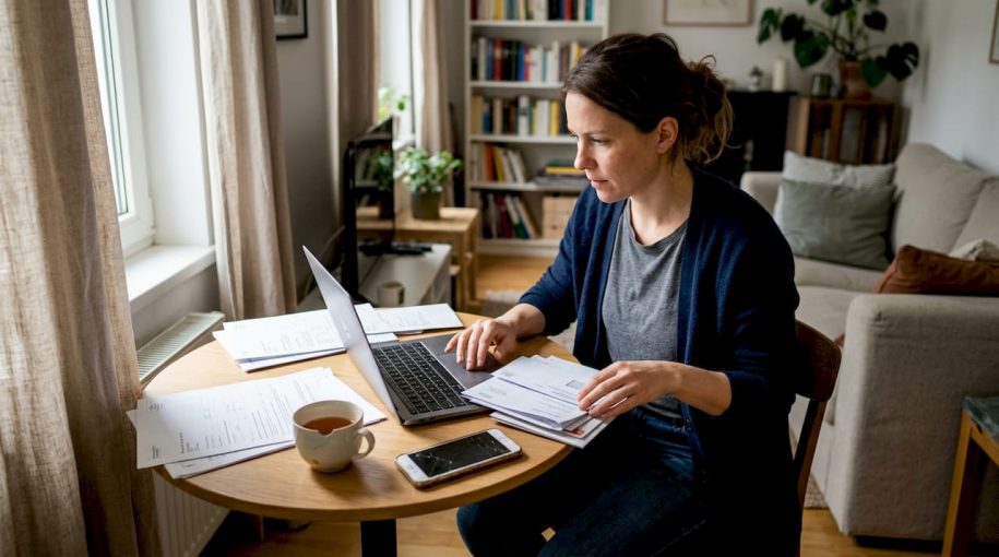Woman handling short-term rental paperwork at home
