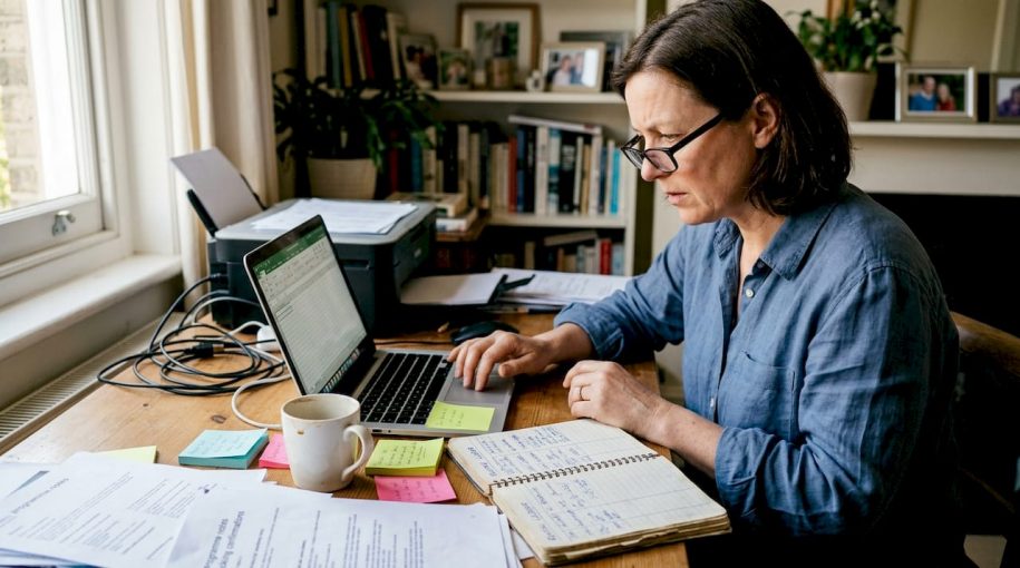 Woman reports rental data in home office