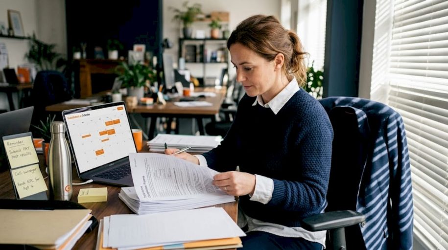 Property manager reviewing compliance paperwork