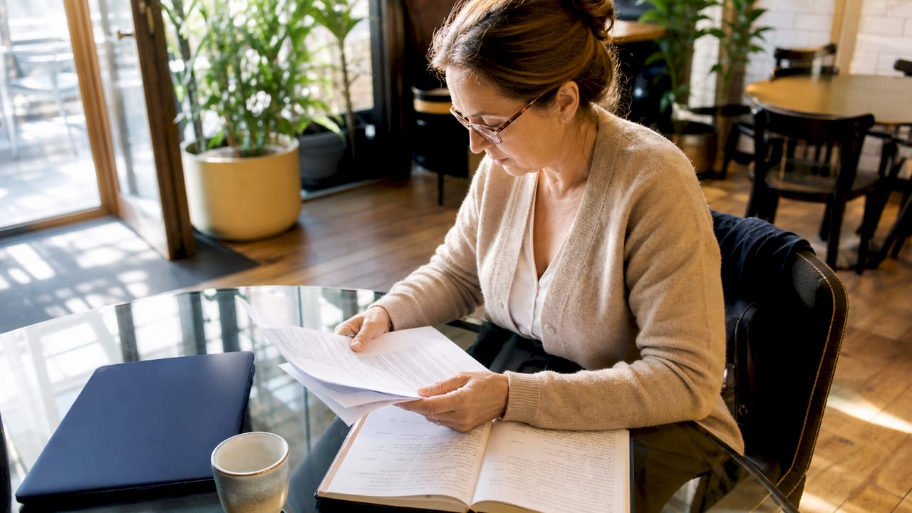 Woman reviewing European rental regulations at desk